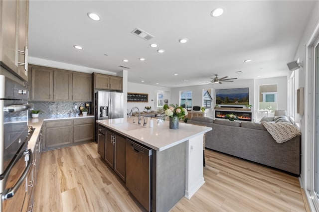 32325 Hillstone St, Temecula, CA 92591 - kitchen with stainless steel appliances, a sink, ceiling fan, light wood-style floors, and recessed lighting
