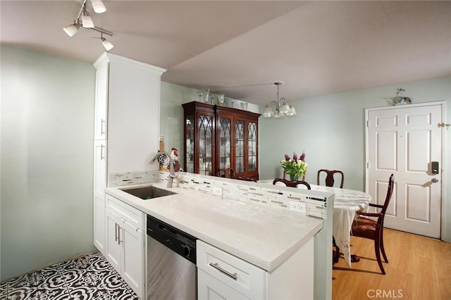 7035 Woodley Ave Unit 204, Van Nuys, CA 91406 - kitchen with dishwasher, a sink, a chandelier, a peninsula, and light countertops