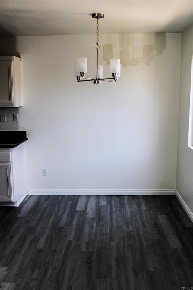 188 S Lincoln Ave Unit 22, El Cajon, CA 92020 - unfurnished dining area with a chandelier, dark wood-type flooring, and baseboards