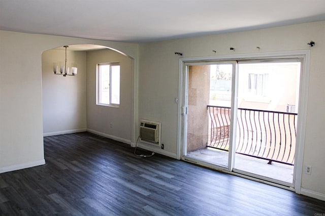 188 S Lincoln Ave Unit 22, El Cajon, CA 92020 - spare room with arched walkways, an AC wall unit, wood finished floors, a chandelier, and baseboards