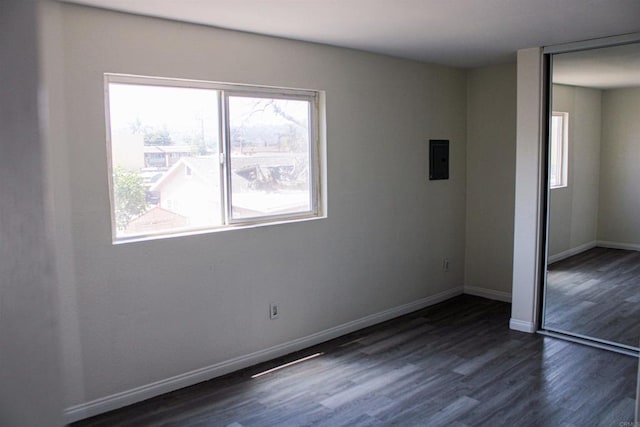 188 S Lincoln Ave Unit 22, El Cajon, CA 92020 - unfurnished bedroom featuring a closet, dark wood-style flooring, baseboards, and electric panel