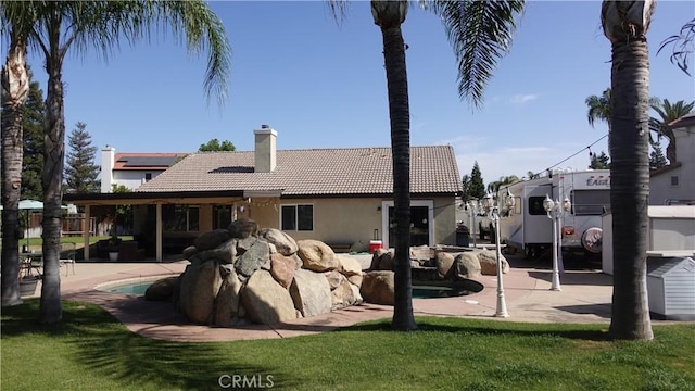 6003 Bluewater Bay Ct, Bakersfield, CA 93312 - rear view of property featuring a tile roof, stucco siding, a chimney, an outdoor pool, and a lawn