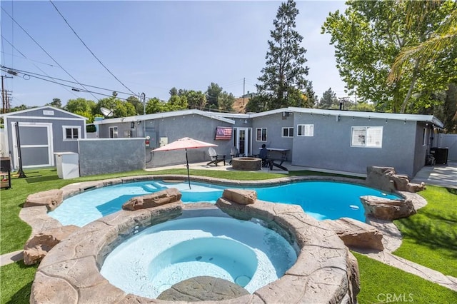 27573 Santa Clarita Rd, Saugus, CA 91350 - rear view of house with an outdoor fire pit, a patio area, a pool with connected hot tub, and stucco siding