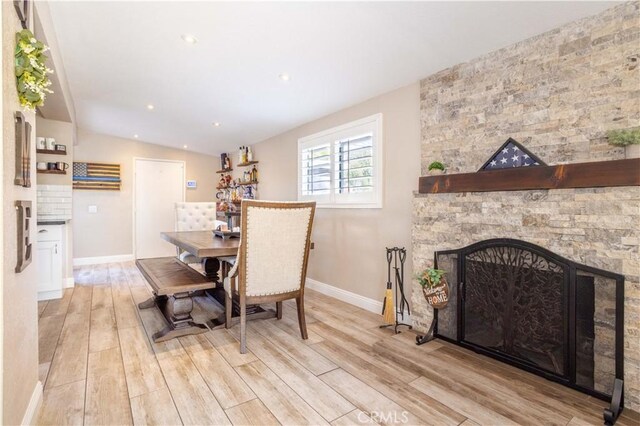 27573 Santa Clarita Rd, Saugus, CA 91350 - dining room with light wood-style floors, baseboards, a fireplace, and recessed lighting