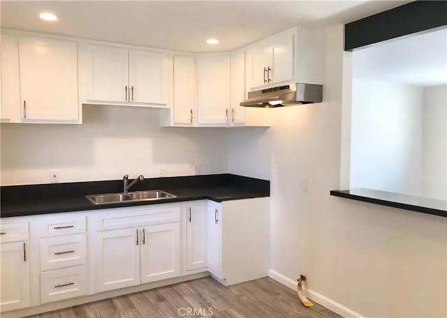 352 W Peach St, Compton, CA 90222 - kitchen featuring a sink, under cabinet range hood, dark countertops, white cabinets, and recessed lighting