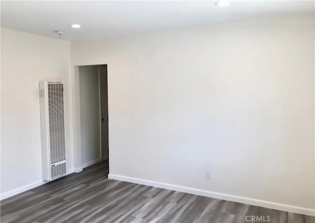 352 W Peach St, Compton, CA 90222 - unfurnished room featuring a heating unit, dark wood-style floors, baseboards, and recessed lighting