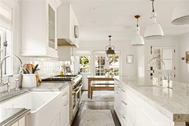 326 Ruby St, Laguna Beach, CA 92651 - kitchen with range with two ovens, a sink, white cabinetry, dark wood finished floors, and ornamental molding