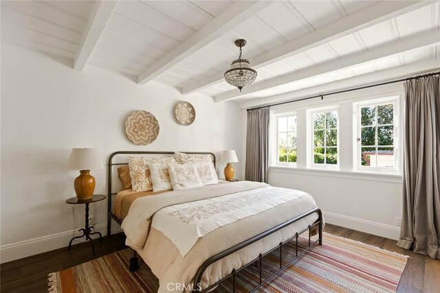 326 Ruby St, Laguna Beach, CA 92651 - bedroom featuring baseboards, beam ceiling, wood finished floors, and a chandelier