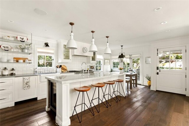 326 Ruby St, Laguna Beach, CA 92651 - kitchen featuring healthy amount of natural light, decorative backsplash, a breakfast bar, dark wood-type flooring, and recessed lighting
