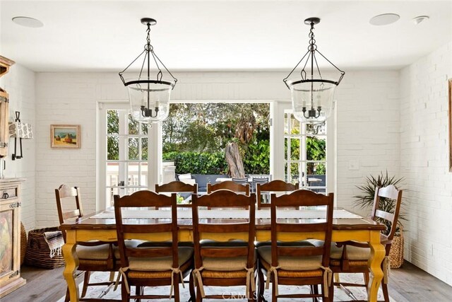 326 Ruby St, Laguna Beach, CA 92651 - dining space with a chandelier, wood finished floors, and brick wall