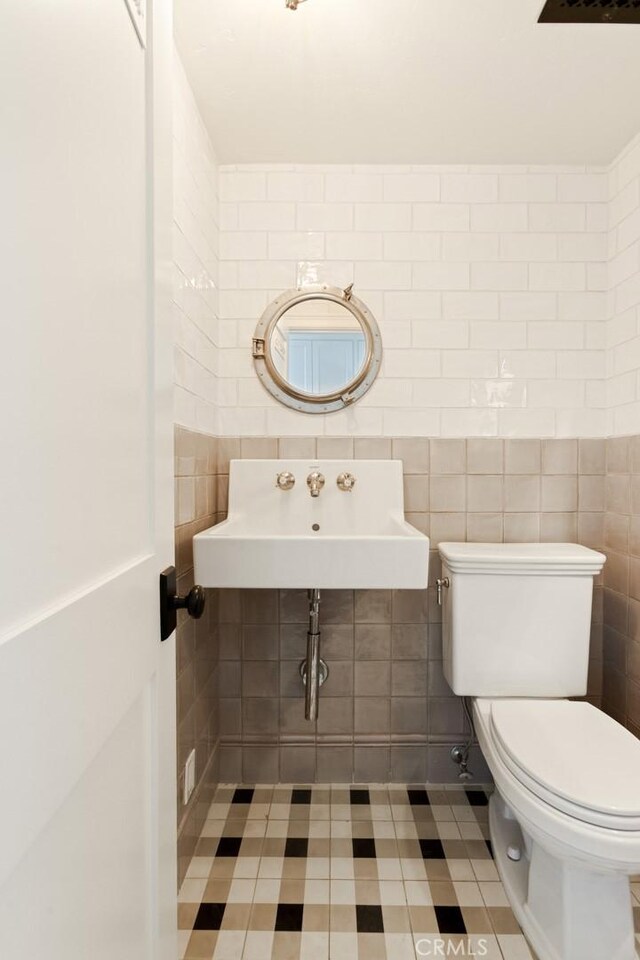 326 Ruby St, Laguna Beach, CA 92651 - half bathroom with a sink, toilet, tile walls, and tile patterned floors