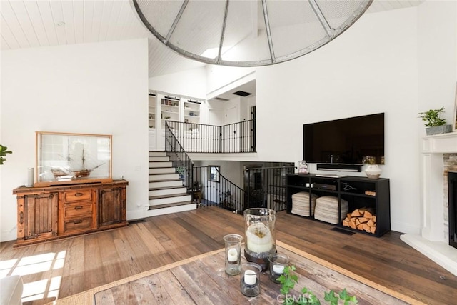 326 Ruby St, Laguna Beach, CA 92651 - living area featuring a fireplace with raised hearth, hardwood / wood-style floors, stairway, high vaulted ceiling, and baseboards