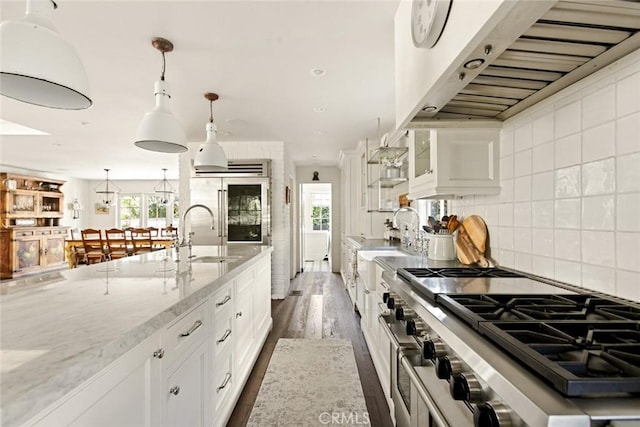 326 Ruby St, Laguna Beach, CA 92651 - kitchen with custom exhaust hood, a sink, white cabinets, high quality appliances, and light stone counters