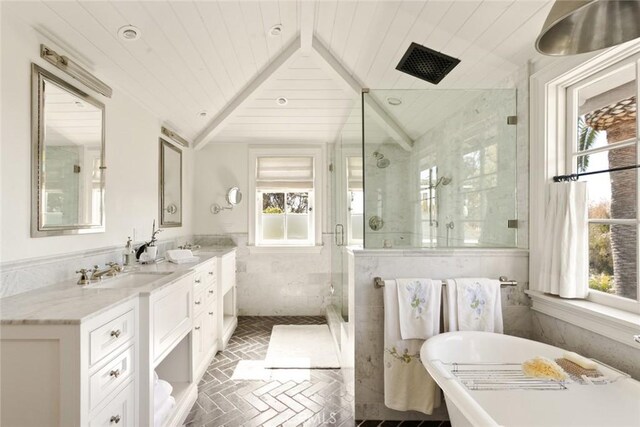 326 Ruby St, Laguna Beach, CA 92651 - bathroom featuring plenty of natural light, a shower stall, a soaking tub, double vanity, and tile walls