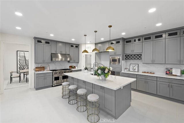 857 Avenida Acapulco, San Clemente, CA 92672 - kitchen with stainless steel appliances, under cabinet range hood, gray cabinetry, decorative backsplash, and recessed lighting