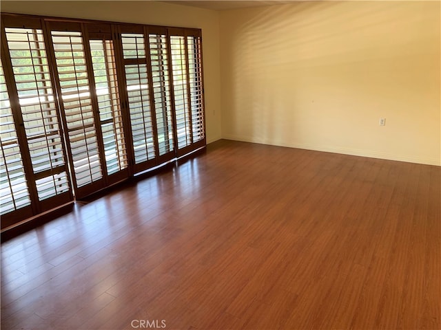 893 Ronda Sevilla Unit B, Laguna Woods, CA 92637 - empty room featuring wood finished floors and baseboards