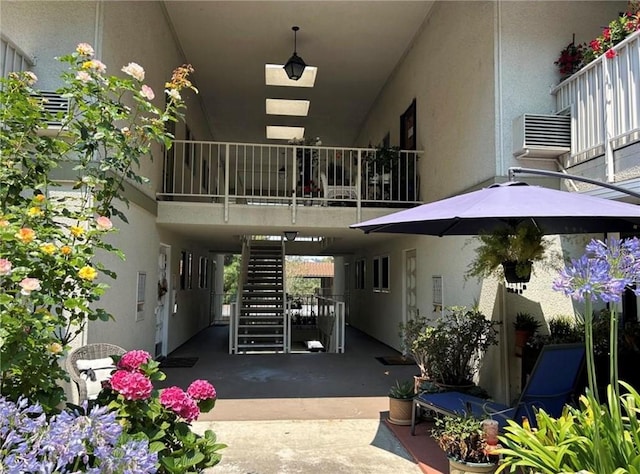 893 Ronda Sevilla Unit B, Laguna Woods, CA 92637 - view of exterior entry featuring stucco siding and a balcony