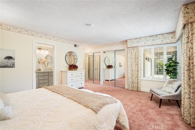 16292 Wishingwell, Huntington Beach, CA 92647 - carpeted bedroom featuring two closets, a textured ceiling, connected bathroom, and baseboards
