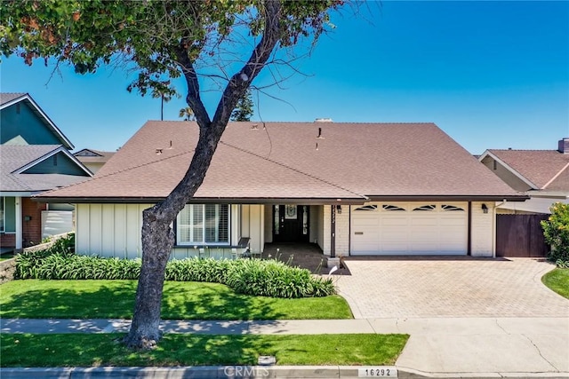 16292 Wishingwell, Huntington Beach, CA 92647 - view of front of house featuring board and batten siding, a garage, decorative driveway, and a shingled roof
