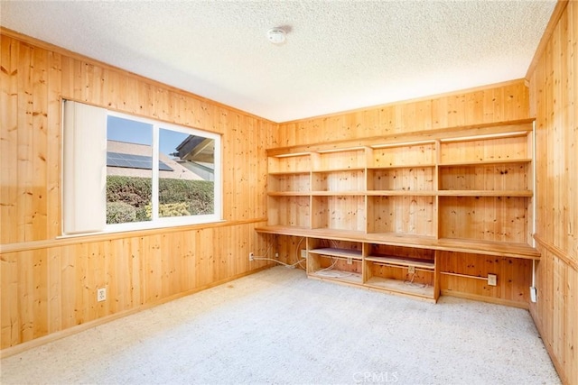 16292 Wishingwell, Huntington Beach, CA 92647 - unfurnished office featuring wooden walls, a textured ceiling, and carpet floors