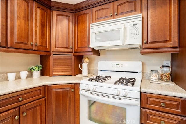16292 Wishingwell, Huntington Beach, CA 92647 - kitchen featuring white appliances, light countertops, and brown cabinetry