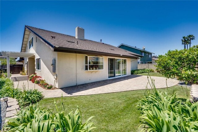 16292 Wishingwell, Huntington Beach, CA 92647 - back of property with a pergola, a patio, stucco siding, and a chimney