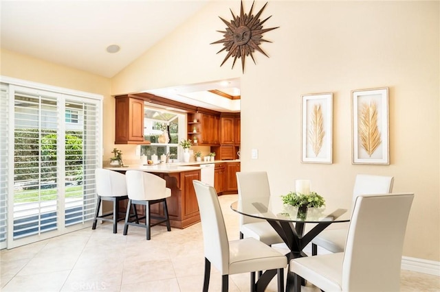 16292 Wishingwell, Huntington Beach, CA 92647 - dining space with plenty of natural light, light tile patterned floors, and high vaulted ceiling