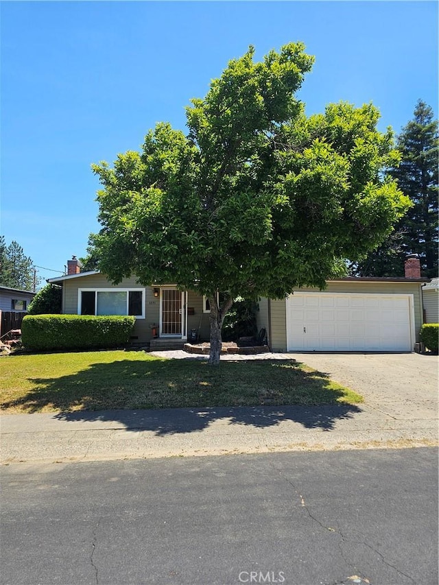 1371 Yokayo Dr, Ukiah, CA 95482 - view of property hidden behind natural elements with a garage, a chimney, and driveway