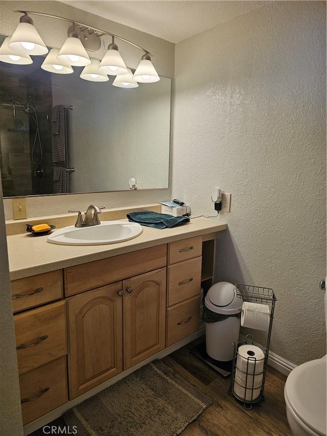 1371 Yokayo Dr, Ukiah, CA 95482 - bathroom featuring wood finished floors, vanity, a shower, a textured wall, and toilet
