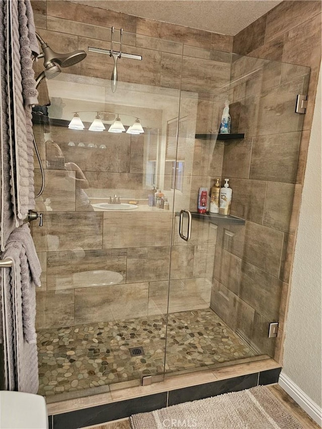 1371 Yokayo Dr, Ukiah, CA 95482 - full bathroom with a shower stall, toilet, a sink, baseboards, and wood finished floors
