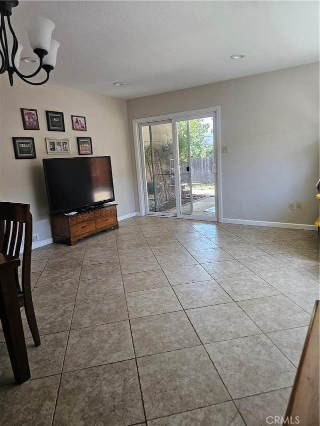 1371 Yokayo Dr, Ukiah, CA 95482 - tiled living area with baseboards, a chandelier, and a textured ceiling