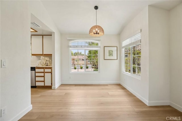 119 Gallery Way, Tustin, CA 92782 - unfurnished dining area featuring light wood-type flooring, a chandelier, and baseboards