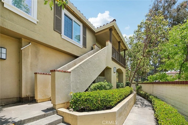 119 Gallery Way, Tustin, CA 92782 - view of side of home with stucco siding and a balcony
