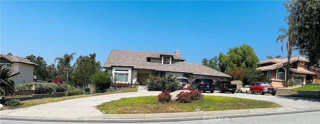 5218 Rocky Mountain Pl, Rancho Cucamonga, CA 91737 - view of front facade with driveway, an attached garage, and a chimney