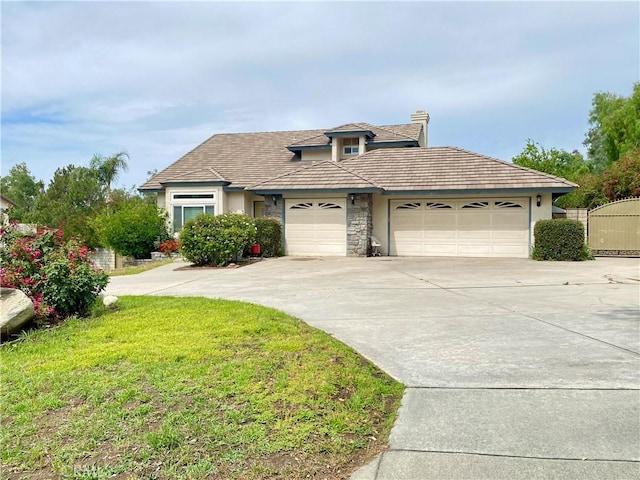 5218 Rocky Mountain Pl, Rancho Cucamonga, CA 91737 - traditional-style home with an attached garage, driveway, stucco siding, a front yard, and stone siding