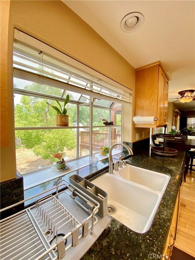 5218 Rocky Mountain Pl, Rancho Cucamonga, CA 91737 - kitchen with wood finished floors, a ceiling fan, and dark stone countertops