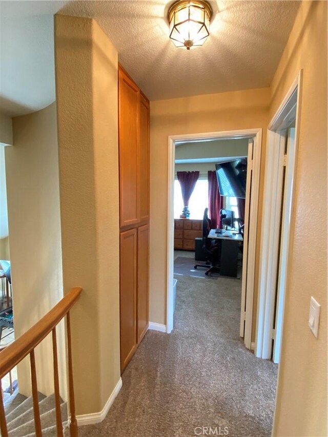 5218 Rocky Mountain Pl, Rancho Cucamonga, CA 91737 - hall featuring dark carpet, an office area, and a textured ceiling