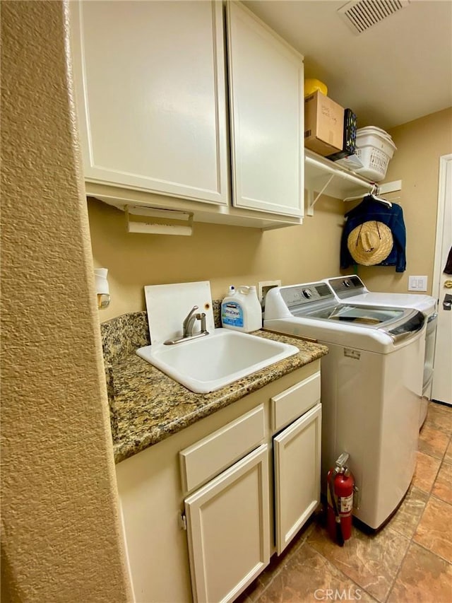 5218 Rocky Mountain Pl, Rancho Cucamonga, CA 91737 - washroom with washing machine and dryer, cabinet space, and light stone finish floors