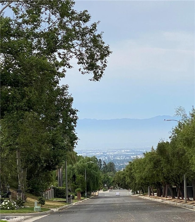 5218 Rocky Mountain Pl, Rancho Cucamonga, CA 91737 - view of asphalt street featuring street lights and curbs