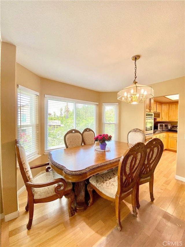 5218 Rocky Mountain Pl, Rancho Cucamonga, CA 91737 - dining room featuring light wood-style floors, a chandelier, and plenty of natural light