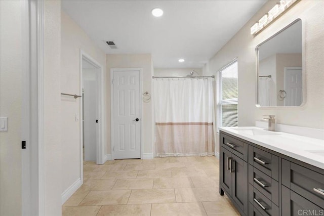 858 Via Barquero, San Marcos, CA 92069 - full bathroom with double vanity, baseboards, a shower with shower curtain, recessed lighting, and tile patterned flooring