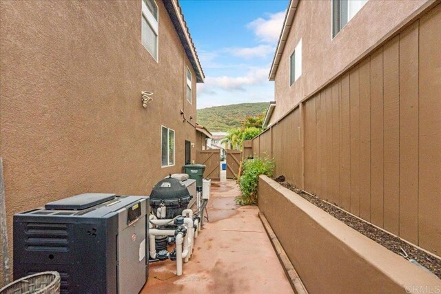 858 Via Barquero, San Marcos, CA 92069 - view of side of home featuring stucco siding and a gate