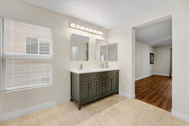 858 Via Barquero, San Marcos, CA 92069 - bathroom with double vanity, baseboards, and wood finished floors