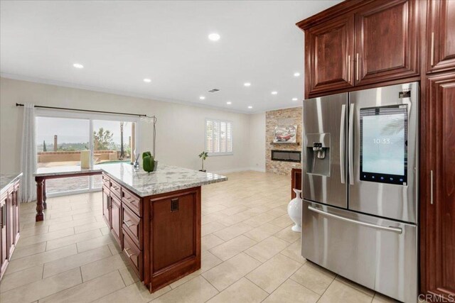 858 Via Barquero, San Marcos, CA 92069 - kitchen featuring stainless steel refrigerator with ice dispenser, ornamental molding, recessed lighting, light stone countertops, and light tile patterned floors