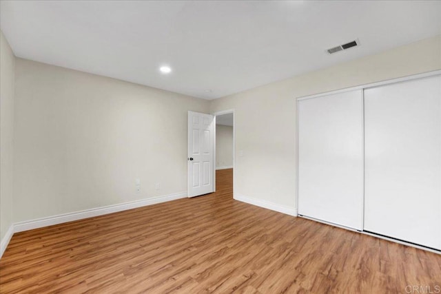 858 Via Barquero, San Marcos, CA 92069 - unfurnished bedroom featuring baseboards, light wood-style floors, a closet, and recessed lighting