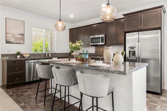 15975 Osprey Ave, Chino, CA 91708 - kitchen featuring stainless steel appliances, dark brown cabinetry, a center island, a sink, and crown molding