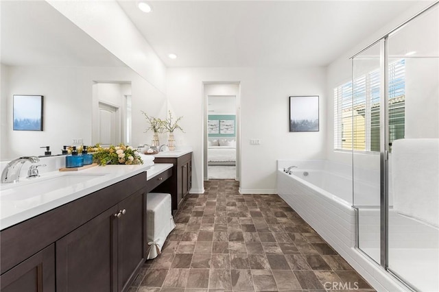15975 Osprey Ave, Chino, CA 91708 - bathroom featuring vanity, a bath, ensuite bathroom, recessed lighting, and baseboards