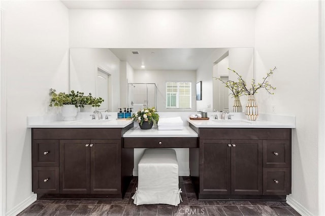 15975 Osprey Ave, Chino, CA 91708 - full bathroom featuring a shower stall, two vanities, and baseboards