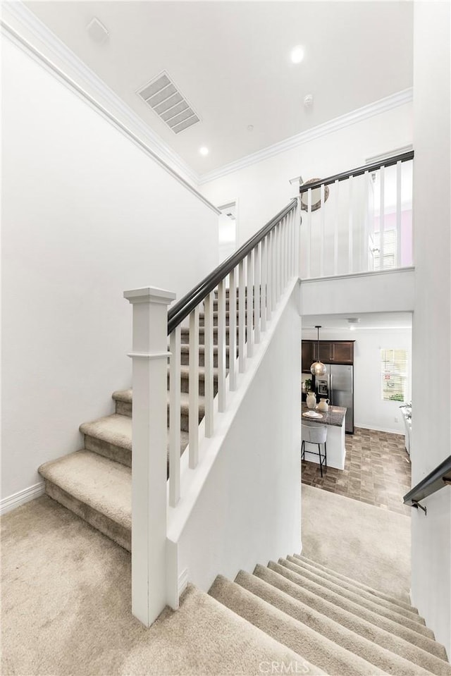 15975 Osprey Ave, Chino, CA 91708 - stairs with carpet flooring, crown molding, baseboards, recessed lighting, and a towering ceiling