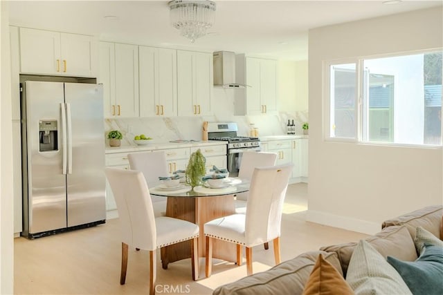 8213 Ethel Ave, North Hollywood, CA 91605 - dining area featuring plenty of natural light, baseboards, and light wood-type flooring